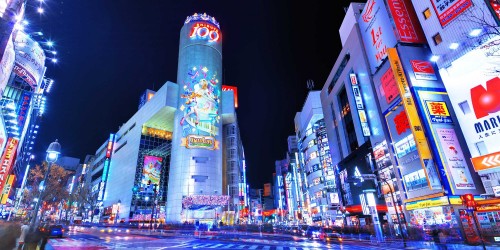 Image city buildings with lights turned on during night time