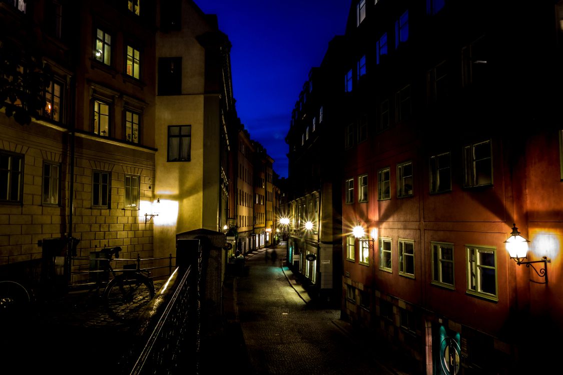 People Walking on Sidewalk Near Building During Night Time. Wallpaper in 5472x3648 Resolution