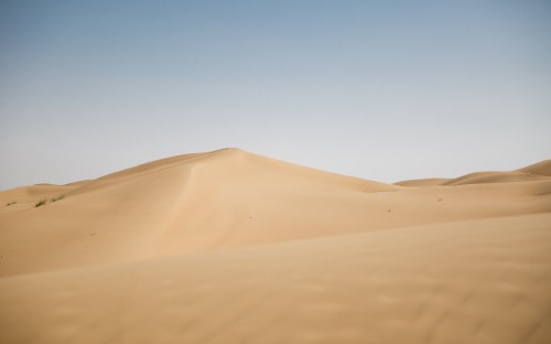 Image brown sand under blue sky during daytime