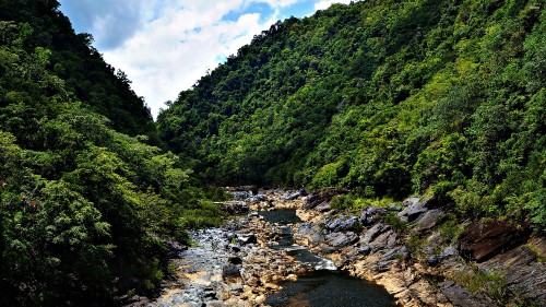 Image green mountains and river under blue sky during daytime