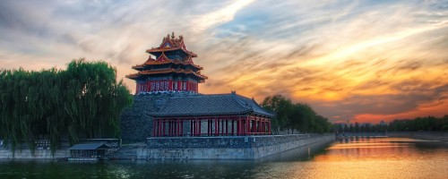 Image red and white temple near body of water during daytime