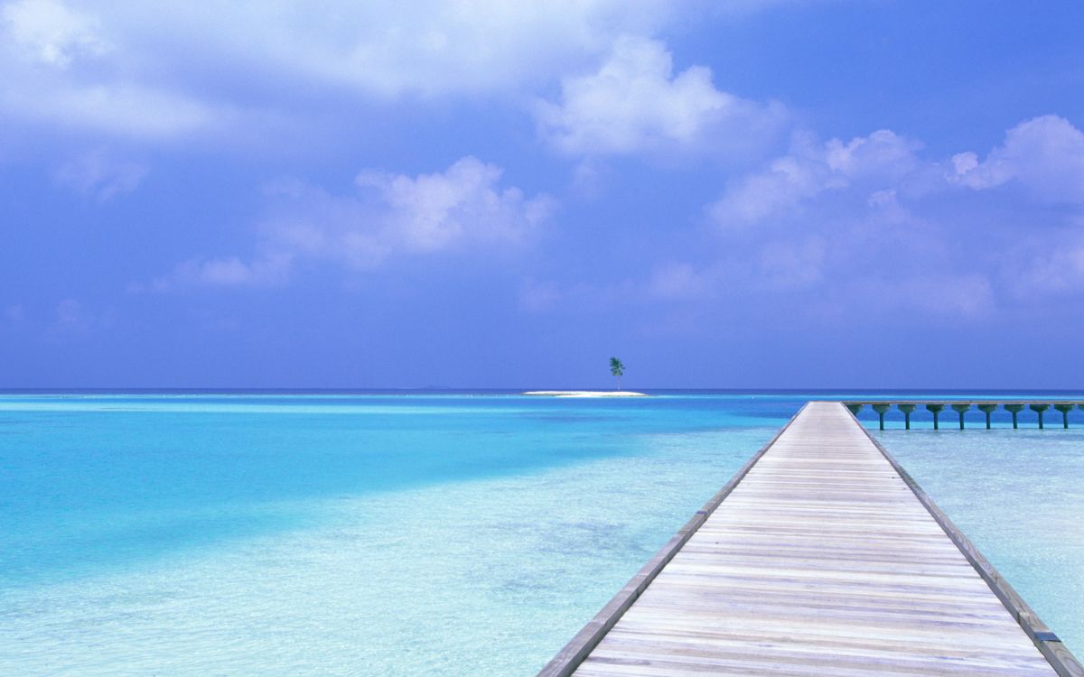 Brown Wooden Dock on Blue Sea Under Blue Sky During Daytime. Wallpaper in 2560x1600 Resolution