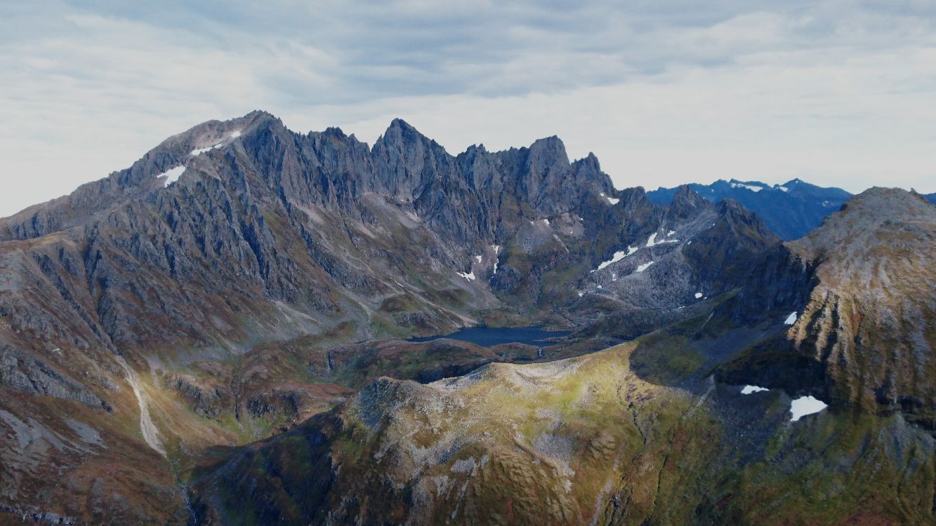 green and brown mountains under white clouds during daytime