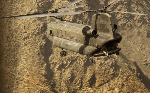 Image gray and black fighter plane on brown rocky mountain during daytime