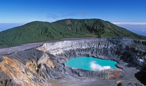 Image body of water between mountain under blue sky during daytime