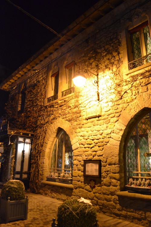 Image brown brick building with light turned on during night time