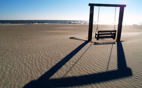 Image brown wooden lifeguard chair on beach during daytime