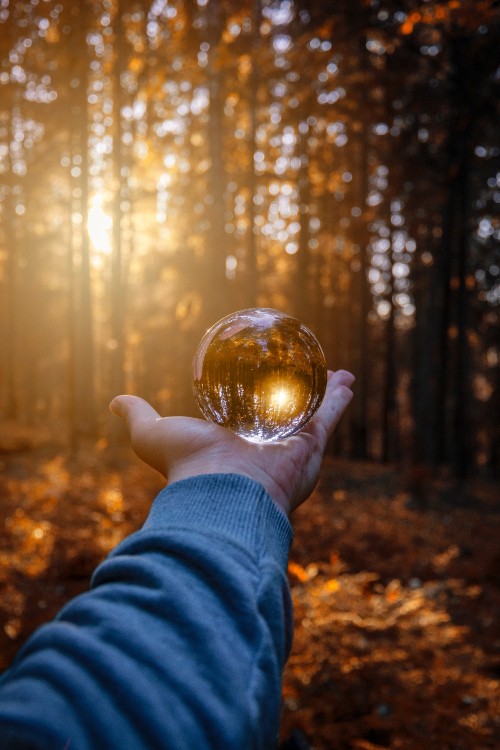 Image person holding clear glass ball