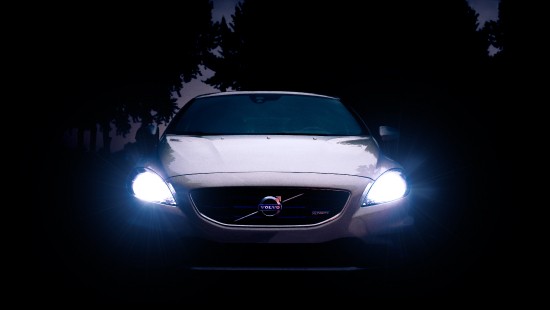 Image white car with light turned on during night time
