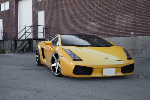 Image yellow ferrari 458 italia parked near brown brick building