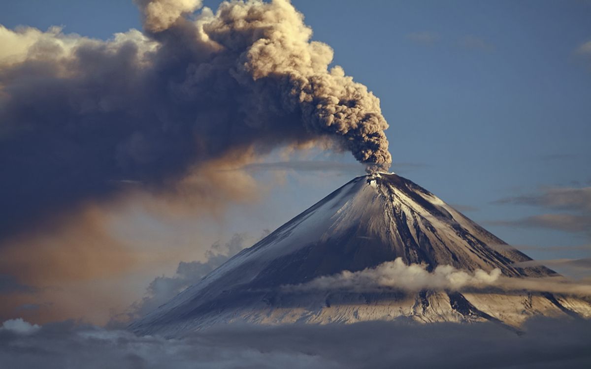 white clouds over snow covered mountain