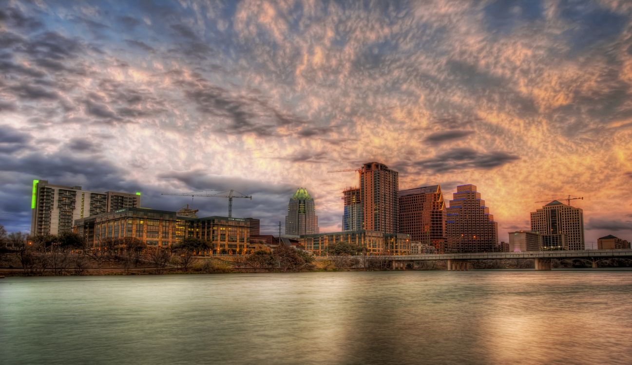 city skyline under cloudy sky during daytime