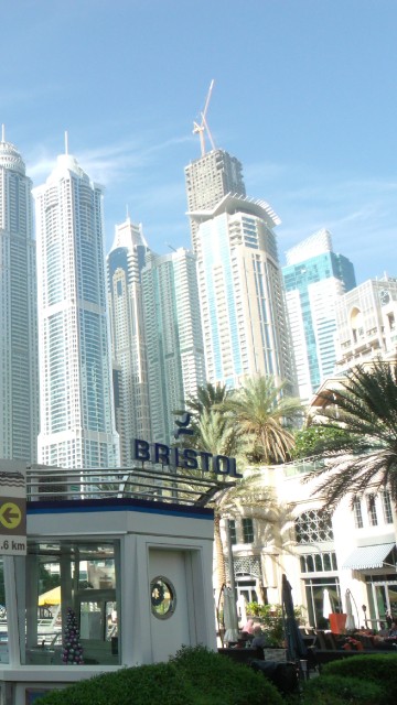 Image people walking on street near high rise buildings during daytime