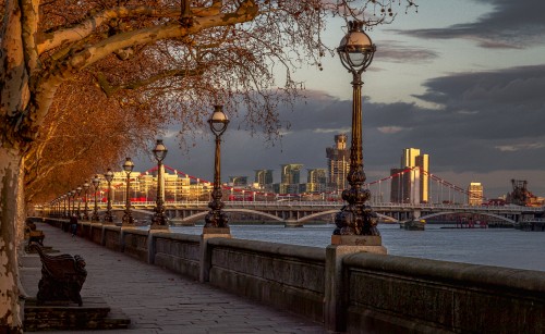 Image black street lamp near body of water during sunset