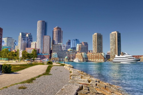 Image city skyline near body of water during daytime