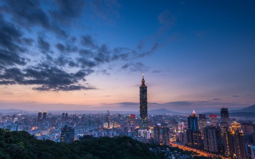 Image city skyline under blue sky during night time