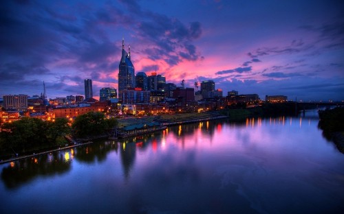 Image city skyline near body of water during night time