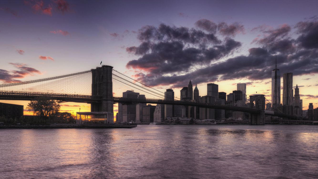 bridge over water under cloudy sky during daytime