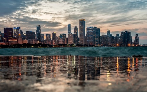 Image city skyline across body of water during daytime