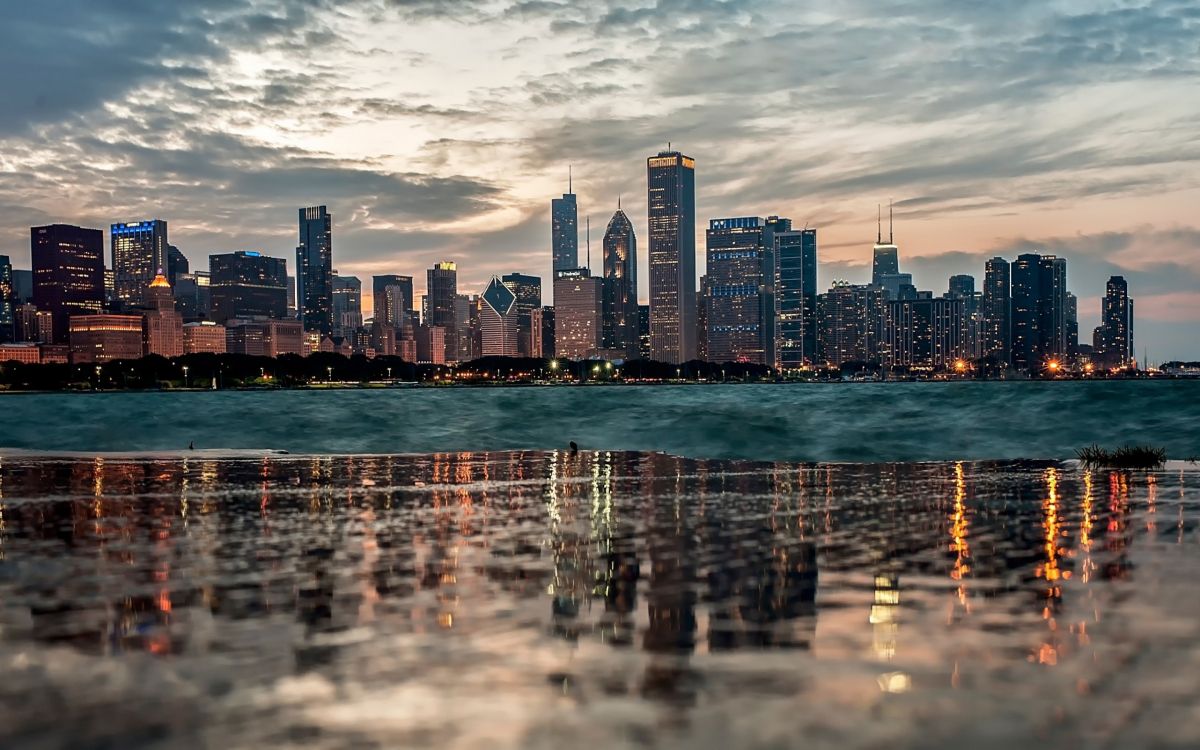 city skyline across body of water during daytime