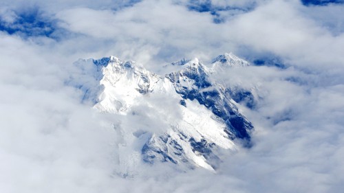 Image snow covered mountain under cloudy sky during daytime