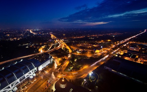 Image city with high rise buildings during night time