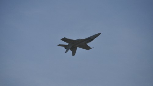 Image black jet plane in mid air