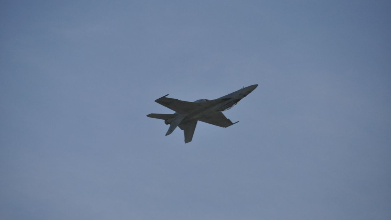 black jet plane in mid air