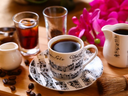 Image white and black ceramic mug with brown liquid inside