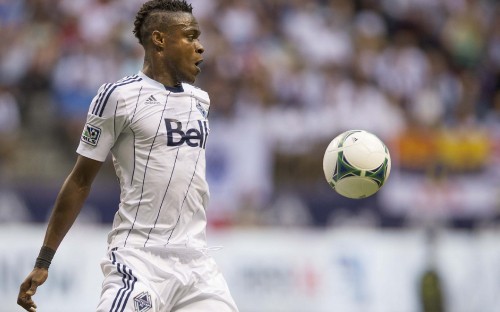 Image man in white soccer jersey shirt holding white and green soccer ball