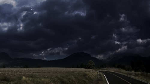 Image gray asphalt road under gray cloudy sky