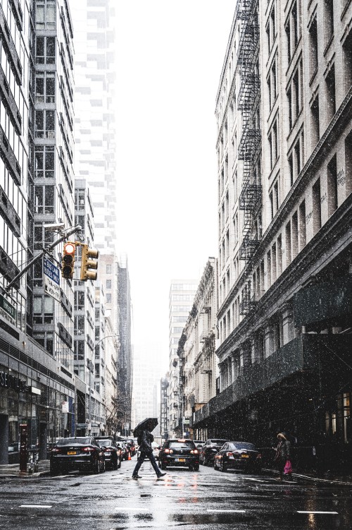 Image people walking on street between high rise buildings during daytime