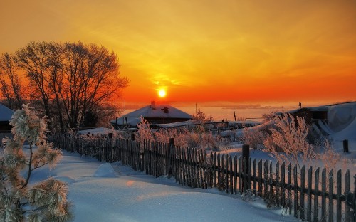 Image snow covered fence during sunset