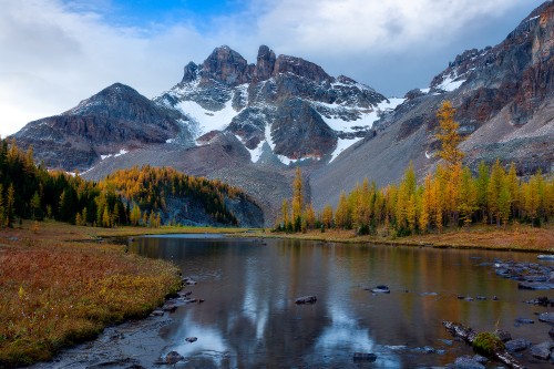 Image lake near snow covered mountain during daytime