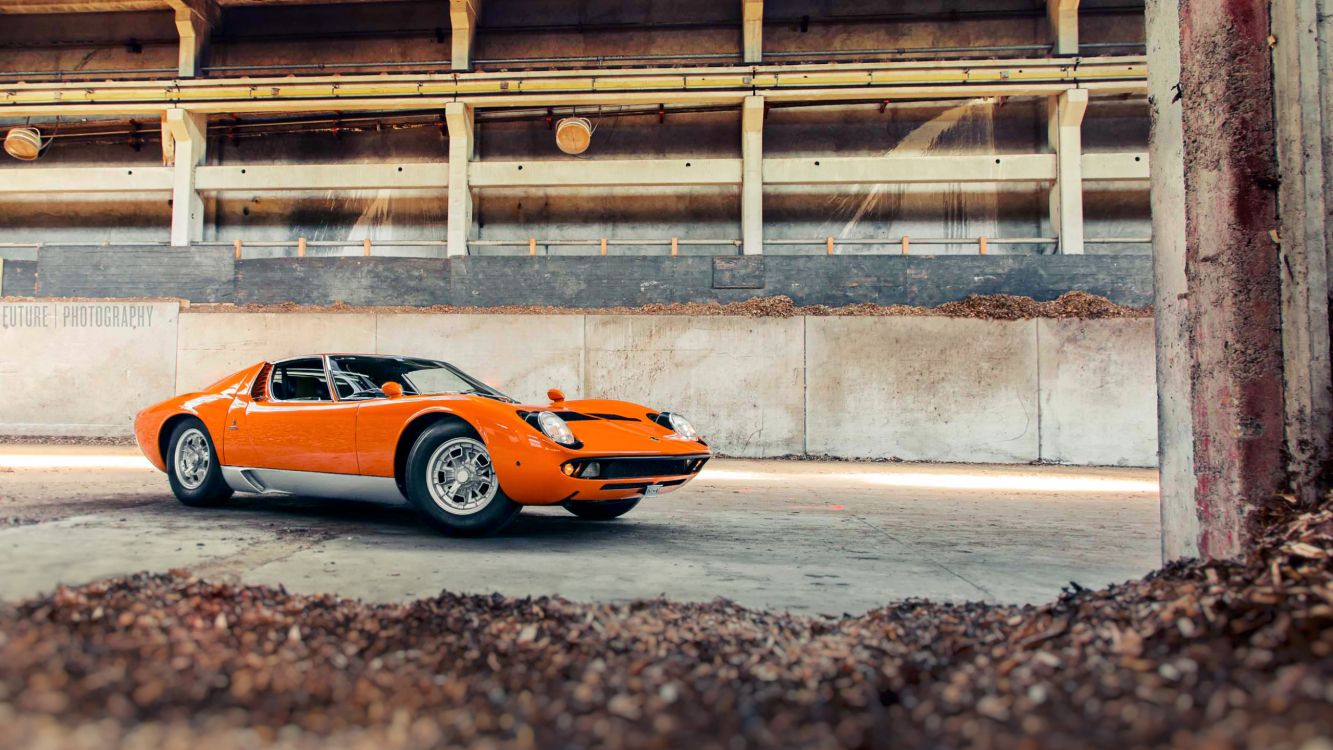 orange and black lamborghini aventador parked on gray concrete road during daytime