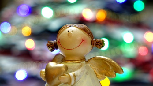 Image white angel ceramic figurine in bokeh photography