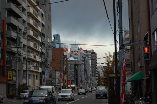 Image cars on road between high rise buildings during daytime