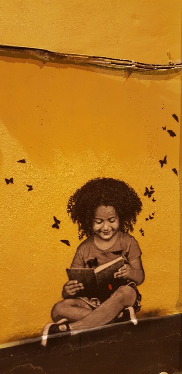 Image woman in brown leather jacket holding book