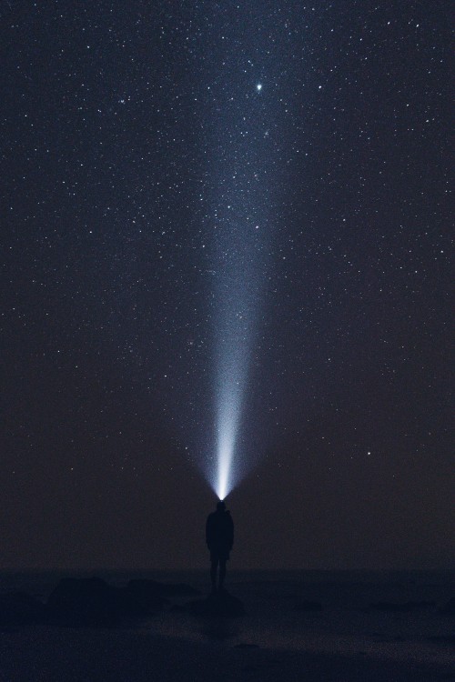 Image man in black jacket standing under starry night