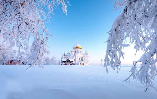 Image white and brown dome building on snow covered ground during daytime