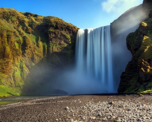 Image waterfalls on rocky mountain under blue sky during daytime