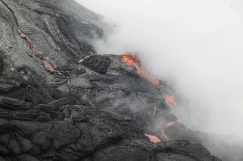 Image black and orange smoke on black rock