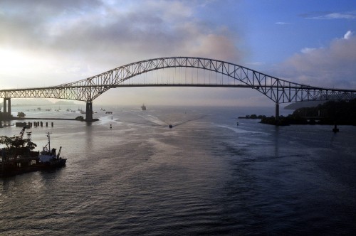 Image gray metal bridge over body of water during daytime