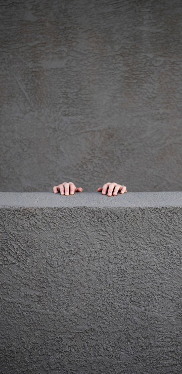 Image person standing on gray concrete floor