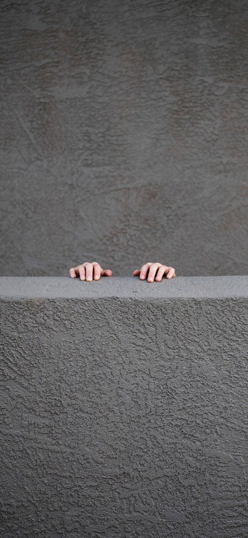 Image person standing on gray concrete floor