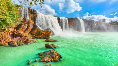 Image waterfalls under blue sky and white clouds during daytime