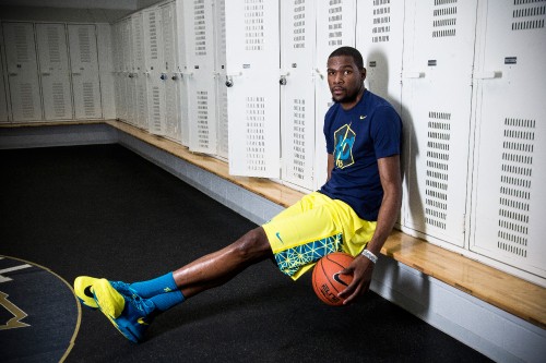 Image man in blue and yellow nike soccer jersey holding basketball