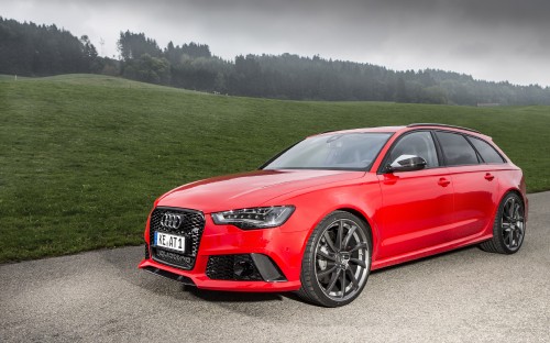 Image red audi coupe on green grass field during daytime