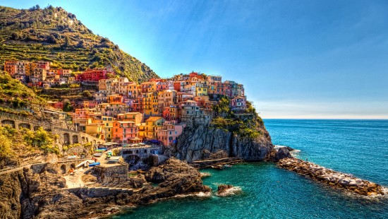 Image houses on mountain beside sea during daytime