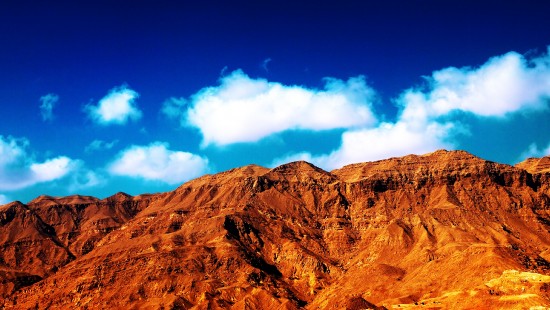 Image brown rocky mountain under blue sky during daytime